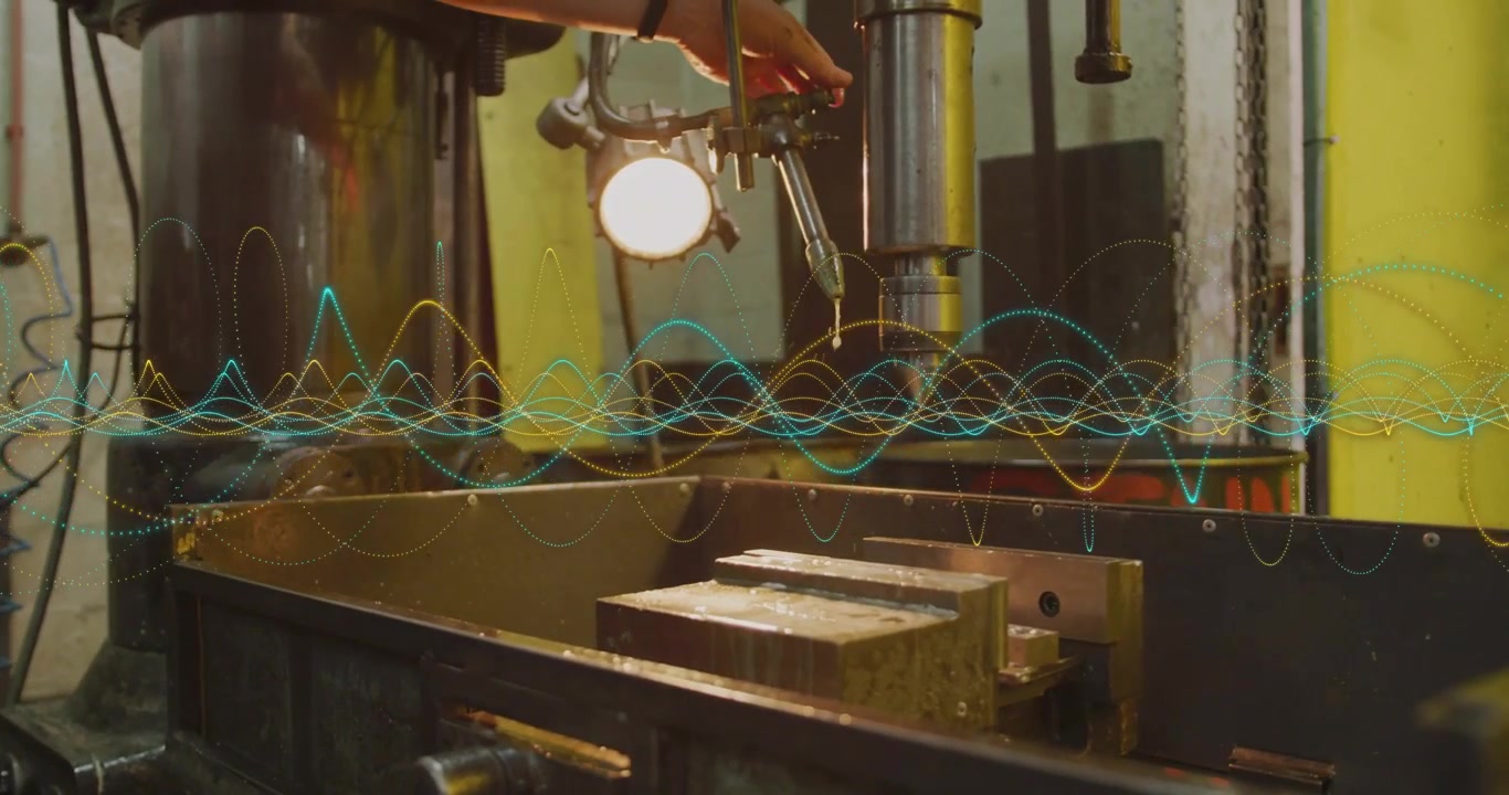 Male tech hand adjusting coolant nozzle, pulling feed lever, causing spray cooling drill press