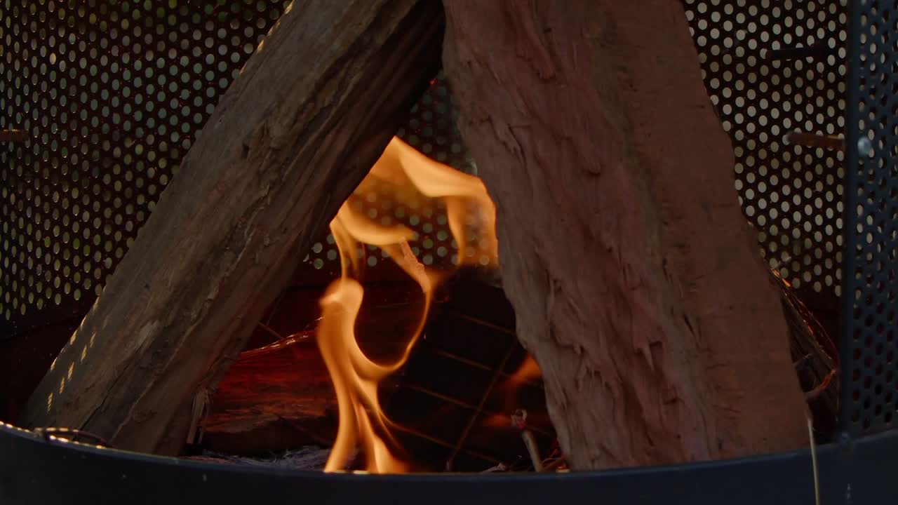 Orange Flames flicker and start to burn wooden logs on a fireplace