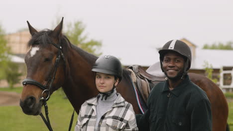 two people touching and petting a horse