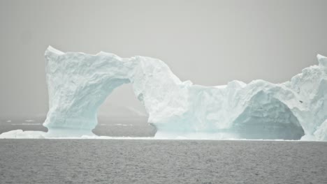 stunning iceberg with holes and very high in antarctica