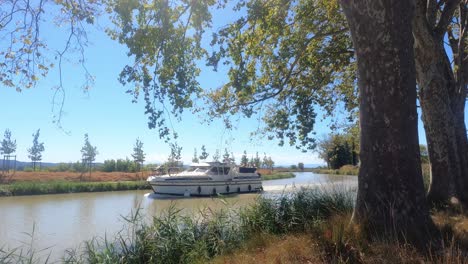 boat cruising down the canal du midi, the good life in the south of france