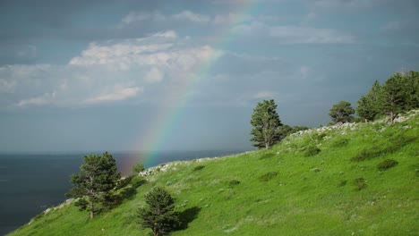 A-rainbow-forming-over-the-hills-of-Boulder,-Colorado,-USA