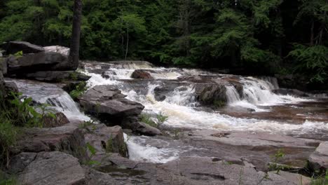 A-waterfall-flows-through-the-forest-in-New-Hampshire-1