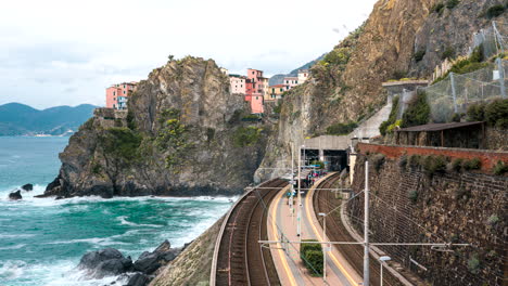 time lapse of an outdoor train station in manarola, italy on a warm summer day