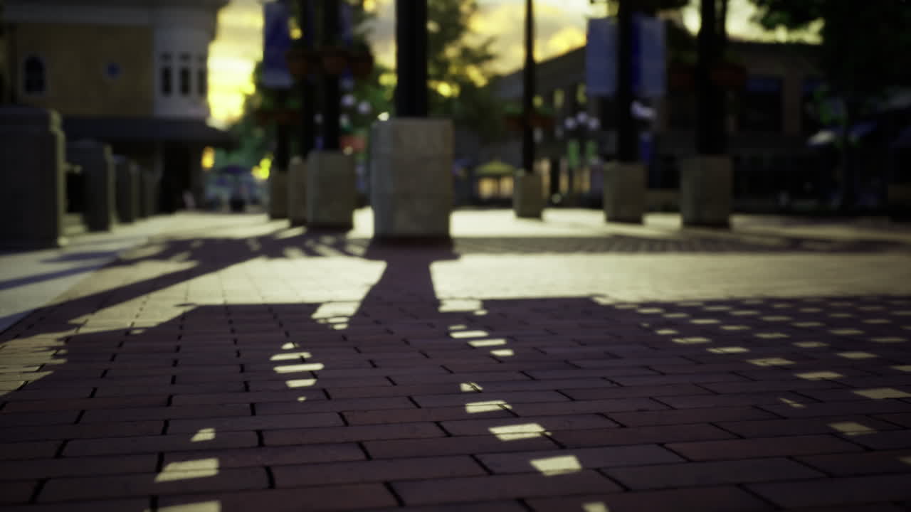 City streets awaken at golden hour with shadows playing across the pavement