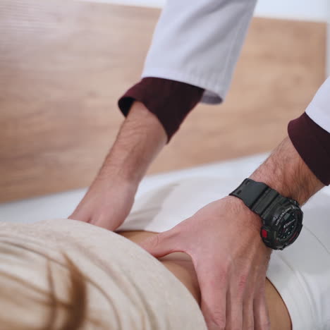 professional doctor examines female's spine. woman patient has problems with her back. physical therapist doing check up of a woman in clinic. spinal concept.