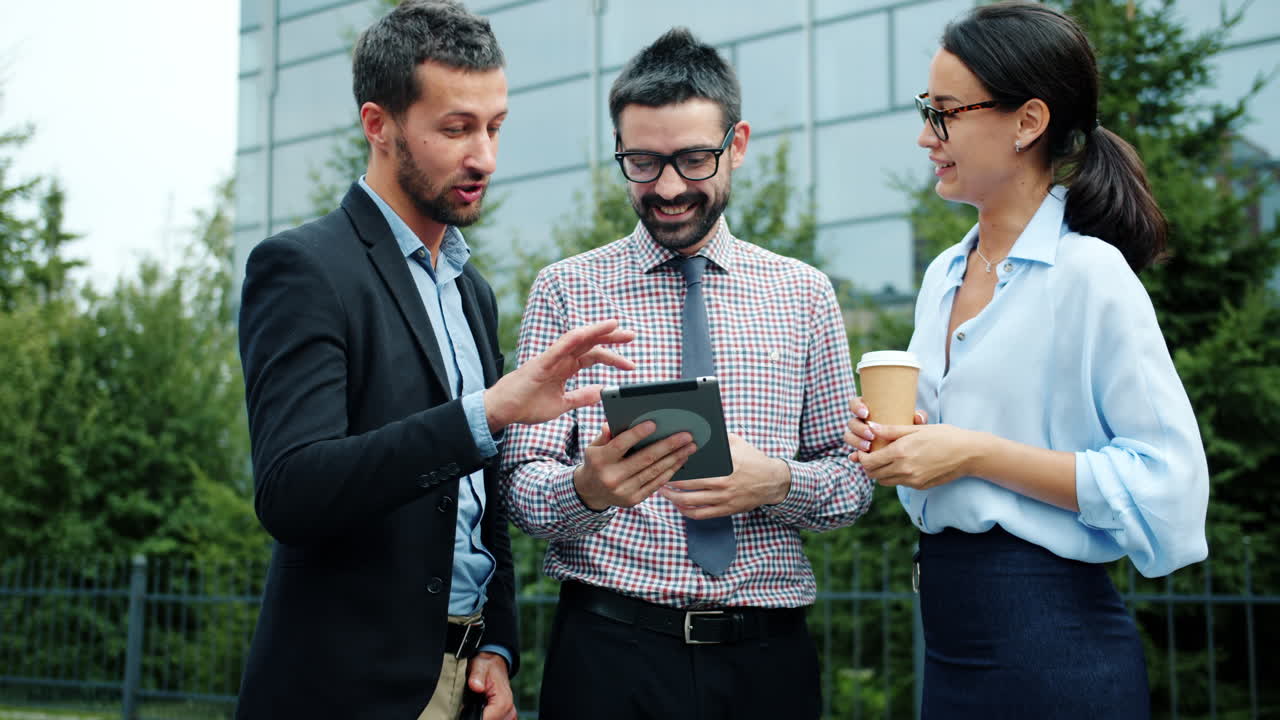 Business People Discussing Project on Tablet