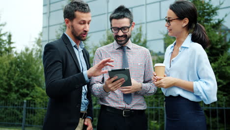 business people discussing project on tablet