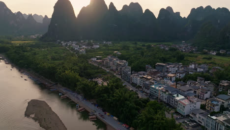 aerial view panning in front of the xingping town and mountains, sunset in china