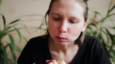 young girl is enjoying eating vegetarian fruit pizza.