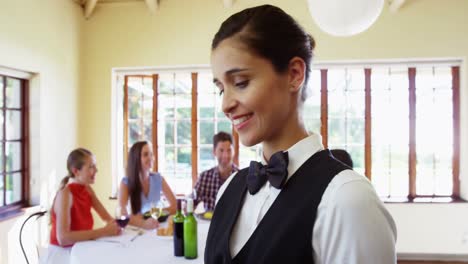 female waitress serving food to costumers