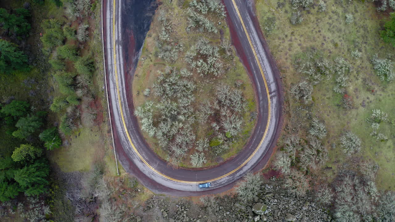 Aerial View of a Car on a Winding Road