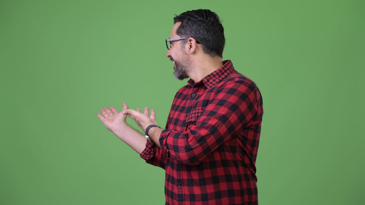 Handsome Persian bearded man showing something