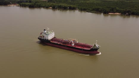 lateral view of large cargo ship of oil products tanker sailing by amazon river