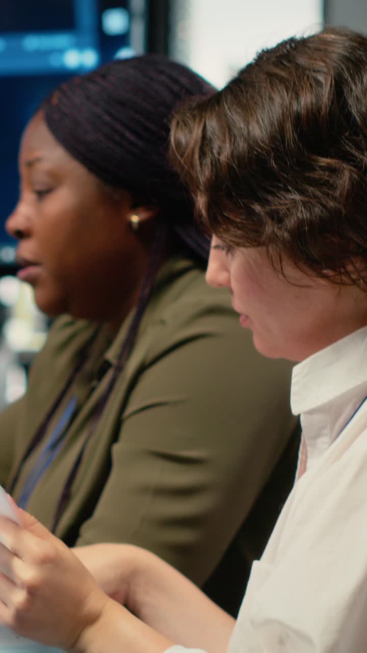 Vertical video Software developers in startup office brainstorming leveraging AI tech