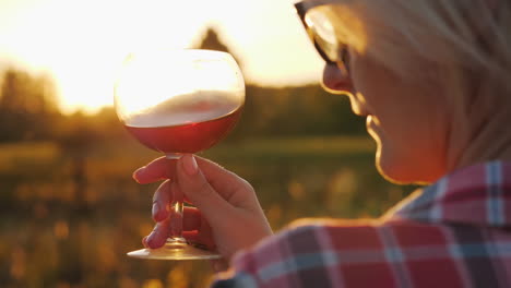 woman with wine at sunset