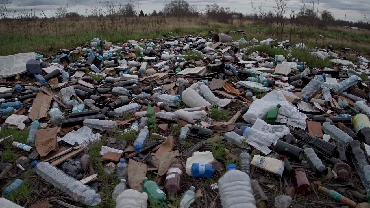 Large Pile of Plastic Waste and Trash in a Field