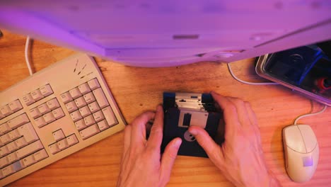 Using diskette for old computer. Music recorder, playing retro computer games. Vintage device for office, obsolete technology. . High quality 4k footage