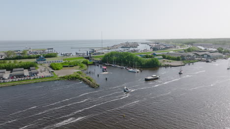 the harbour at lauwersoog in the netherlands, as observed from above. the video showcases the coastal infrastructure, as well as the surrounding green landscape that leads into the north sea