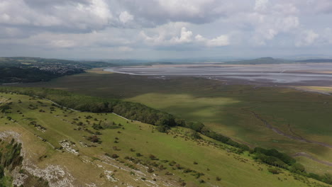 Aerial-shot-looking-over-the-coast-line-on-the-west-coast-of-England,-bright-sunny-day