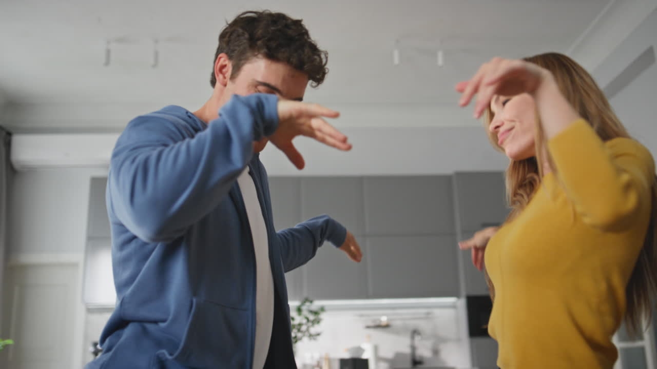 Happy family enjoying dance living room closeup. Boyfriend girlfriend having fun