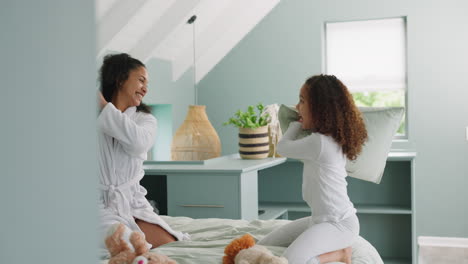 love, mother and girl pillow fight