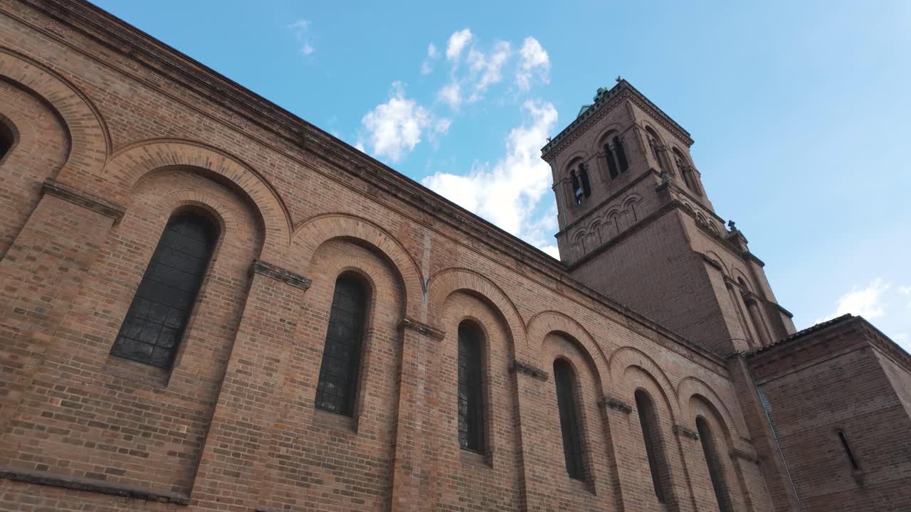 Brick Church Exterior with Tower Under Blue Sky