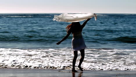 woman raising her sarong in the air