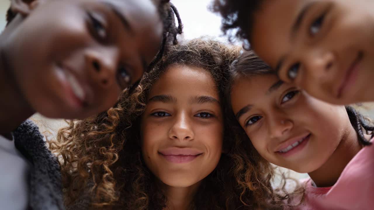 A Group of Four Children Smiling and Posing Cheerfully Together, Showcasing Their Joyful Expressions and Close Friendship in a Warm, Natural Setting Full of Positive Energy and Connection