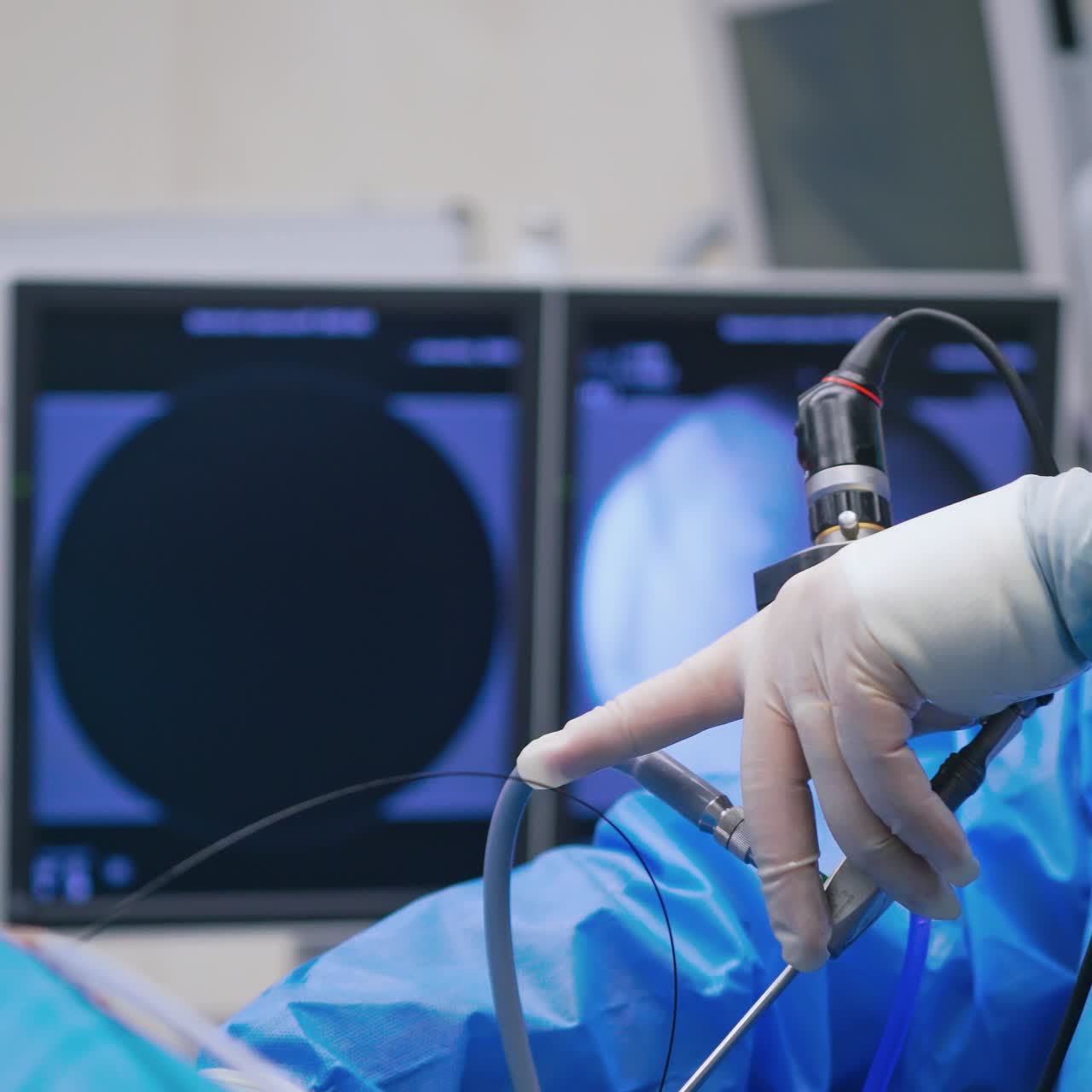 Doctor with new medical equipment. Specialist in medical uniform uses modern instrument during surgery. Close-up.