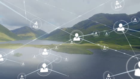 animation of connected icons over aerial view of lake between mountains against cloudy sky