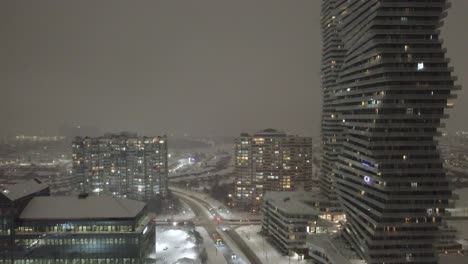 aerial establishing shot of downtown mississauga after a blizzard at night