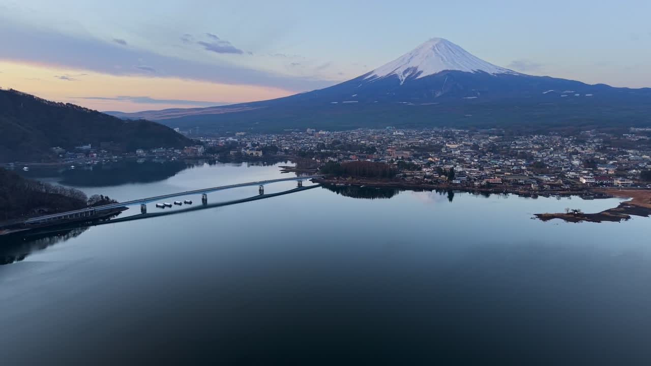 Aerial drone view of Lake Kawaguchiko near the Fujikawaguchiko town, Japan with Mount Fuji on the background in the evening
