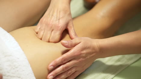 decontracting leg massage, given by a masseuse woman