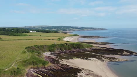 Traeth-Lligwy-Anglesey-eroded-coastal-shoreline-aerial-rising-view-above-Welsh-island-coastline