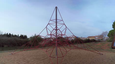 Empty-rope-pyramid-during-the-Covid-19-pandemic,-no-people-in-a-playground-during-lockdown-on-a-sunny-day