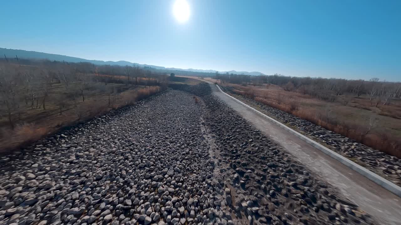 FPV establishing shot of an empty Planas Dam used in severe flooding