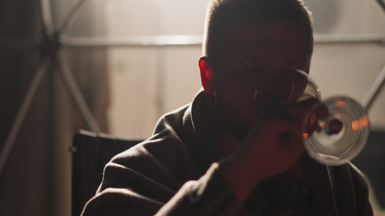 Man drinking wine in a cozy setting