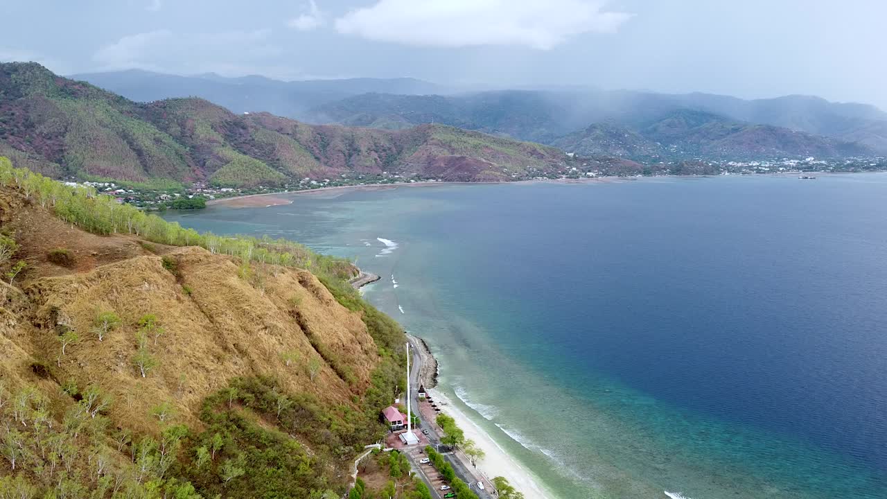 drone aéreo del paisaje de la estación seca, hermoso océano azul y olas onduladas en la remota isla tropical, dili, timor leste