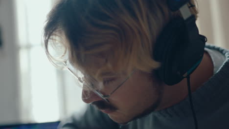 young musician in headphones enjoying playing the guitar