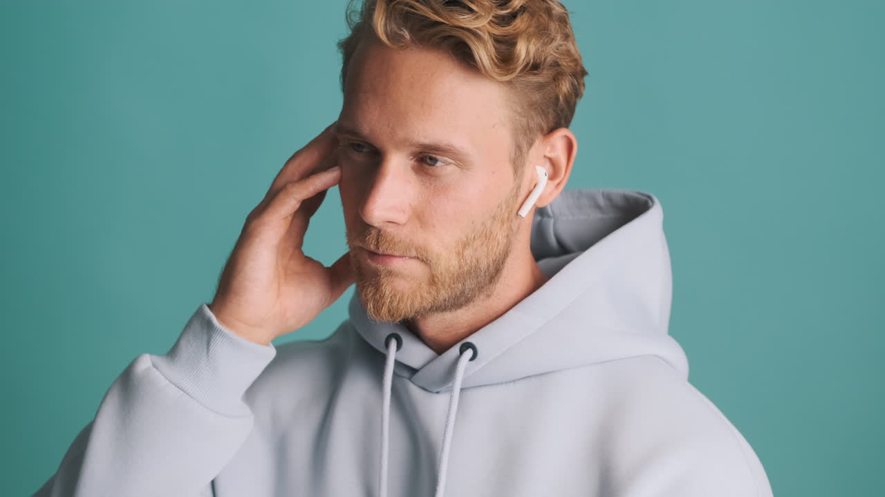 Young man listening to music with earpods