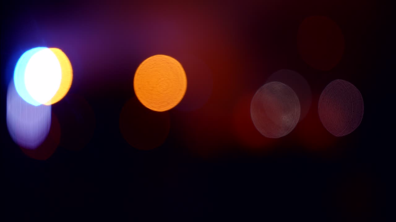 Colorful Bokeh Lights Shifting and Blurring in Darkness