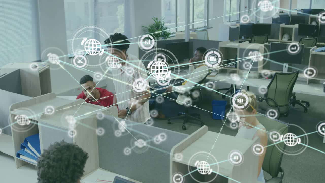 Tech team working at cubicles, standing colleague pointing monitor, initiating network overlay