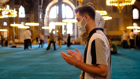 young masked worshiping inside hagia sophia