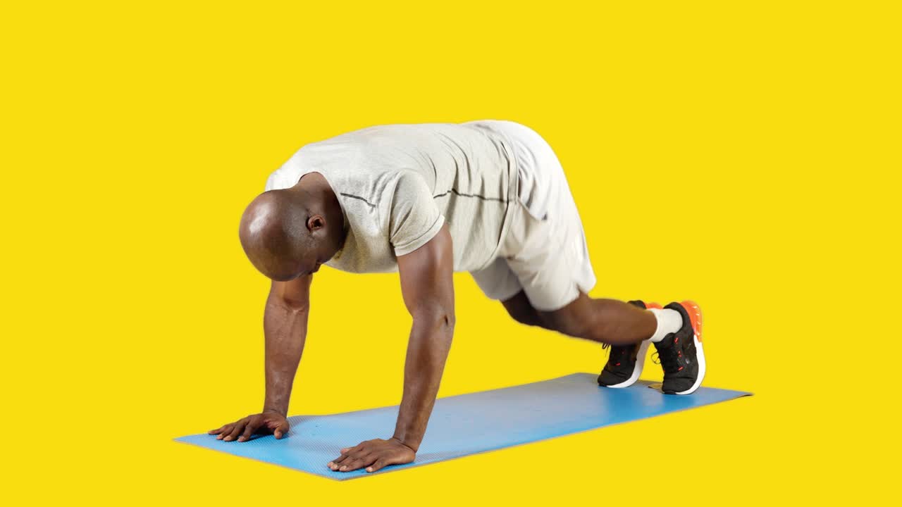 Man Performing Mountain Climber Exercise on Mat
