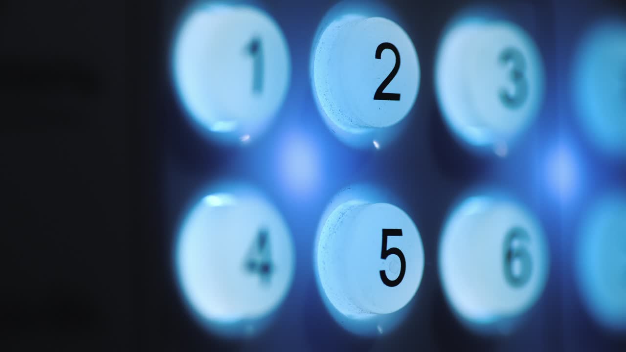 Closeup shot of A person enters a pin code on a backlit keyboard