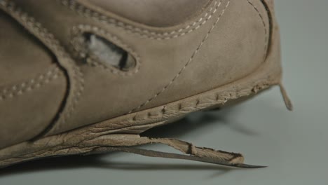 macro dolly of torn shoe sole of worn hiking boot