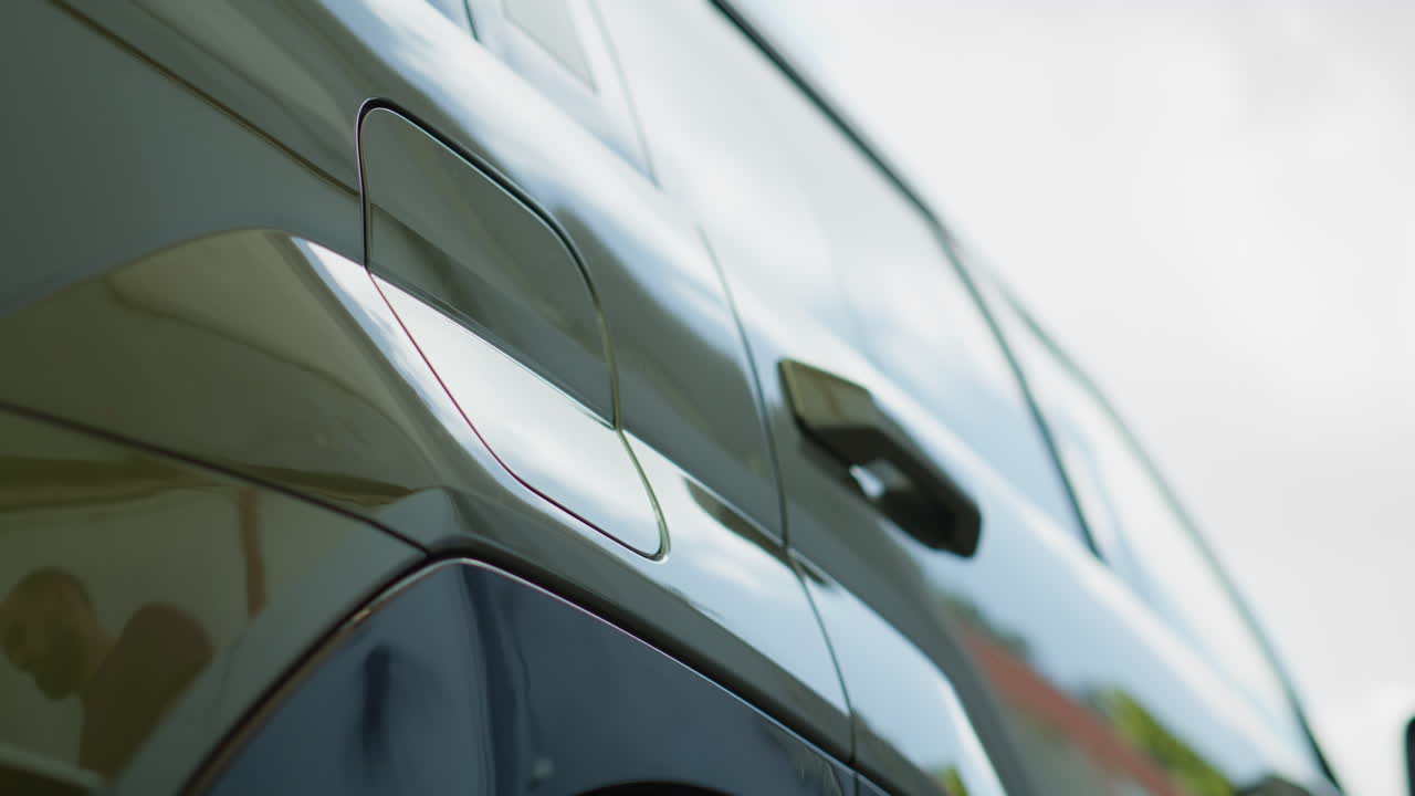 Close Up Of Driver Disconnecting Ev Vehicle From Charging Dock, Low Angle Shot