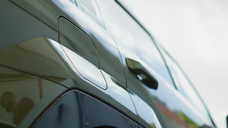 close up of driver disconnecting ev vehicle from charging dock, low angle shot
