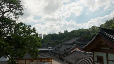 Day-timelapse-over-Bongeunsa-Temple-buildings-with-fluffy-soft-clouds-movement-in-summer